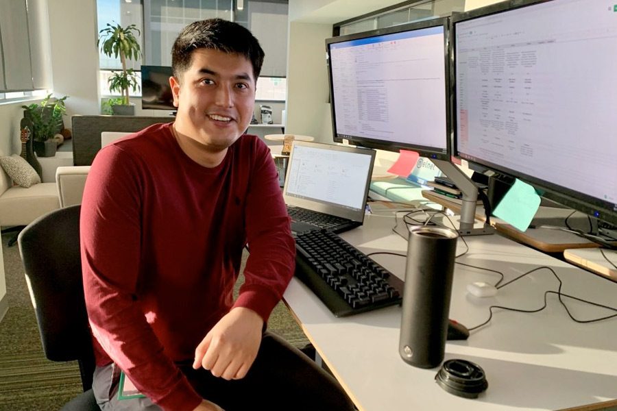 Ram Sabyrkulov seated at desk in front of a computer
